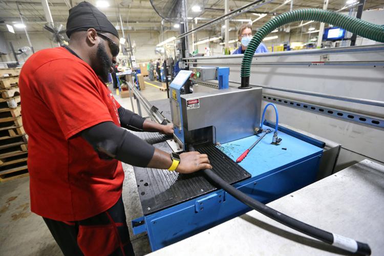 Nate Williams cuts a hydraulic hose